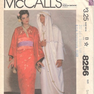 May include: A sewing pattern for a red and white costume. The pattern is for a woman's kimono and a man's robe. The pattern number is 8256 and the size is small. The pattern is from McCall's.