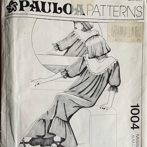 May include: A Paulo Patterns sewing pattern envelope, number 1004, for misses' sizes S, M, L, XL. The front features a black and white illustration of a long dress with a ruffled collar, puffed sleeves, and a tiered skirt, with a circular inset view.