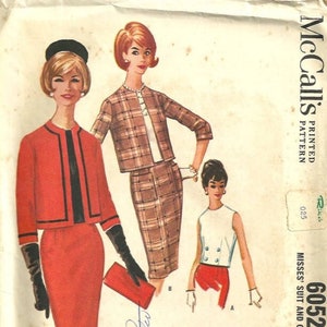 May include: Vintage McCall's sewing pattern for a women's suit and overblouse. The pattern is for size 12, bust 32. The pattern shows a red suit with a black trim and a white overblouse with black buttons.