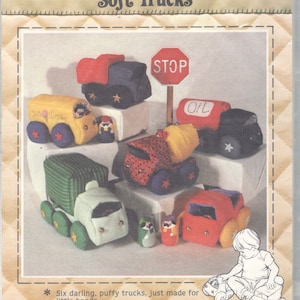 May include: A sewing pattern for six soft, plush toy trucks. The pattern includes a stop sign, an oil truck, a cement mixer, a dump truck, a striped delivery truck, and a red pickup truck. The pattern also includes instructions for making a small toy truck.