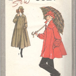 May include: Simplicity sewing pattern number 8829 for a long, loose-fitting coat with a button-up front and a collar. The pattern includes two views: one in a brown color and one in a red color. The pattern is for misses sizes 16.