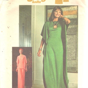 May include: Simplicity sewing pattern number 7211 for a long green dress with a scoop neck and long sleeves. The pattern is for stretch knits only and includes a pick-a-knit rule on the envelope back.