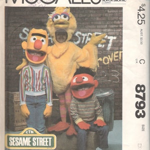 May include: A sewing pattern for Sesame Street costumes. The pattern includes instructions for making costumes for Big Bird, Elmo, and Cookie Monster. The pattern is from McCall's and is size extra small.