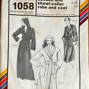 May include: A white paper sewing pattern envelope for Stretch & Sew 1058, featuring illustrations of a hooded robe and a shawl-collar coat. The text includes 'hooded and shawl-collar robe and coat' and 'Bust Sizes: Small 28-32, Medium 34-38, Large 40-44'.