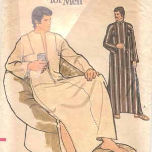 May include: A vintage sewing pattern for a long robe with a zipper closure. The pattern is for men and is called "Very Easy Vogue Patterns for Men". The pattern is from the 1970s and is in good condition.
