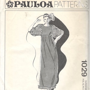 May include: A sewing pattern envelope labeled 1029 PAULOA PATTERNS featuring a line drawing of a floor-length dress with a high waist, gathered bodice, and striped puff sleeves. The pattern includes sizes XS, S, M, L, XL and lists a Honolulu address.