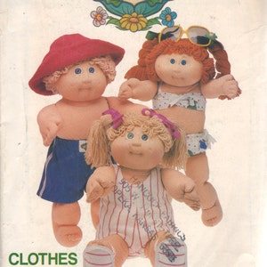 May include: A vintage sewing pattern for Cabbage Patch Kids clothing. The pattern includes instructions for making a swimsuit, a pair of shorts, and a striped shirt. The pattern is illustrated with three Cabbage Patch Kids dolls wearing the finished garments.