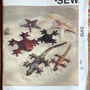 May include: Kwik Sew pattern 2413 featuring fabric starfish and lizards. The pattern cover shows various sea creature designs in metallic and textured fabrics. The pattern is designed by Kerstin Martensson.