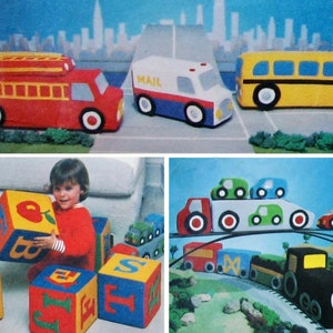 May include: A set of colorful, soft, fabric blocks with letters and images. The blocks are red, yellow, blue, and green. The letters on the blocks are O, B, T, F, I, E, and S. The images on the blocks are an apple, a house, and a star. A child is playing with the blocks.