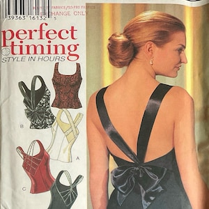 May include: A sewing pattern envelope labeled 2527 STYLE with the text perfect timing STYLE IN HOURS and 2 hour TOPS. The envelope displays illustrations of four sleeveless tops labeled A, B, C, and D, and a photograph of a back-view top with a large bow.