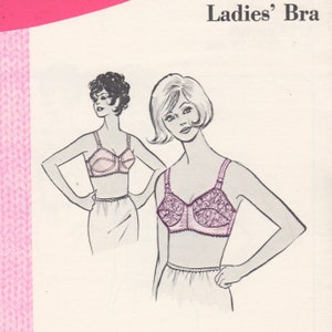 May include: A vintage illustration of two women wearing bras. The bra on the left is a solid pink color, while the bra on the right is a pink lace design. Both women are wearing simple skirts.