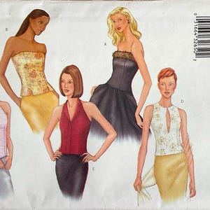 May include: A Butterick sewing pattern envelope 6879 for sizes 18-20-22 featuring illustrations of five different sleeveless tops and dresses. The designs include a light pink halter top, a yellow floral strapless bodice, a red collared halter top, a black strapless dress with fur trim, and a white floral top with a keyhole neckline.