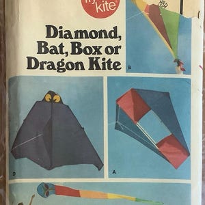 May include: A vintage sewing pattern for a diamond, bat, box, or dragon kite. The pattern includes instructions and diagrams for making the kites. The pattern is from the "go fly a kite" brand.