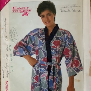 May include: Simplicity sewing pattern for a floral print robe with a black sash. The pattern is for sizes 8-20 and includes instructions for making a robe with a real satin black band.