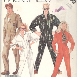 May include: McCall's sewing pattern featuring four jumpsuit designs. The jumpsuits are in various colors, including khaki, white, camouflage, and orange. The pattern includes the size "LARGE". The pattern number is 3252.