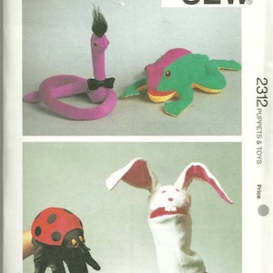 May include: A sewing pattern for making puppets and toys. The pattern includes instructions for making a snake, frog, bunny, and ladybug. The pattern is from Kwik-Sew Pattern Co., Inc. and is number 2312.