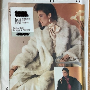 May include: Simplicity sewing pattern number 7078 for a white faux fur coat. The pattern includes instructions for sewing a coat with a large collar and pockets. The pattern is part of the Connoisseur Collection.