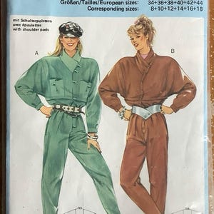 May include: Burda sewing pattern number 6736 for a jumpsuit with shoulder pads. The pattern includes two styles: a green jumpsuit with a collar and a brown jumpsuit with a wrap-style neckline. The pattern includes sizes 34-44 and 8-18.
