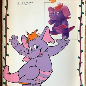 Könnte beinhalten: Ein Vintage-Schnittmuster mit der Figur Eleroo aus der Zeichentrickserie Wuzzles. Das Cover zeigt einen lila Elefanten mit rosa Ohren und orangefarbenem Haar. Das Schnittmuster ist von Butterick.