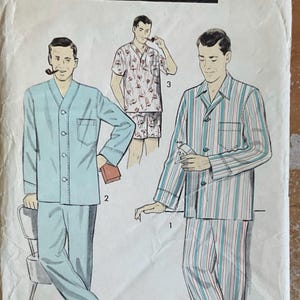 May include: Advance 8217 sewing pattern envelope featuring illustrations of three pajama styles. Style 1 is a striped long-sleeve top and pants. Style 2 is a solid light blue long-sleeve top and pants. Style 3 is a short-sleeve top and shorts.