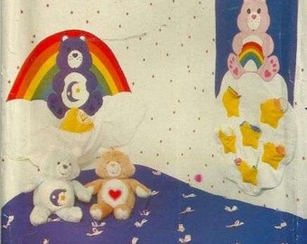 May include: A vintage sewing pattern for Care Bears themed crafts. The pattern includes instructions for making a rainbow and cloud wall hanging, a star-shaped organizer, and three plush Care Bears. The pattern is from Butterick and has the number 6652.