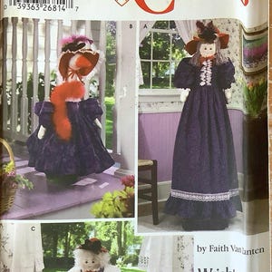 May include: Simplicity Crafts pattern 5464 featuring doll designs. The pattern includes images of dolls in various poses, wearing dresses and hats. The cover has the text "ONE SIZE" and the Simplicity logo.