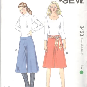 May include: A sewing pattern for a pair of culottes with a wide leg and a fitted waistband. The pattern is for sizes XS-S-M-L-XL and is from Kwik Sew Pattern Co., Inc. The pattern includes instructions for making two different styles of culottes, one with a blue fabric and one with a red fabric.