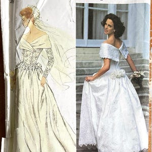 May include: A Simplicity 8243 sewing pattern envelope featuring a white wedding dress with an off-the-shoulder neckline, long lace sleeves, and a full skirt adorned with fabric roses at the waist. The package includes a sketch and a photograph.