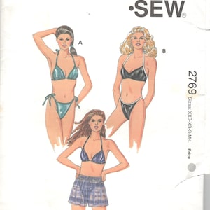 May include: Sewing pattern for a bikini swimsuit with three different styles. The pattern is called "Kwik Sew" and the pattern number is 2769. The pattern includes sizes XXS-XS-S-M-L.