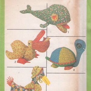 May include: A vintage Simplicity sewing pattern for making four stuffed animal toys: a whale, a duck, a turtle, and a chicken. The pattern number is 8779. The pattern is printed on a green background with white text.