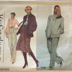 May include: A vintage sewing pattern for a two-piece outfit by Yves Saint Laurent. The pattern is for a jacket and pants, and features a light blue color scheme. The pattern number is 1749. Vogue Paris Original.