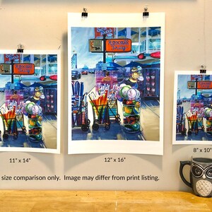 May include: Three different sizes of a painting of a street scene with a Rexall Drug store sign. The painting is in a bright, colorful style with a lot of detail. The painting is 11 inches by 14 inches, 12 inches by 16 inches, and 8 inches by 10 inches.