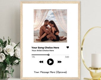 May include: A printable digital download of a music player design with a couple in a romantic setting. The design includes a heart icon, play, pause, and skip buttons, and the text "Your Song Choice Here", "Your Artist Choice Here", "1:15", "3:20", and "Your Message Here (Optional)".
