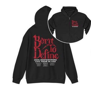 May include: Black zip-up hoodie with a red graphic that reads "Born to Define" and "2026 AMPERS&GONE LIVE TOUR IN USA". The hoodie has a hood and a front pocket. A smaller image of the hoodie is in the upper right corner.