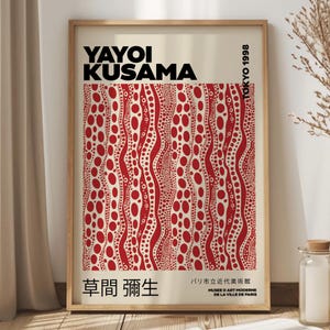 May include: A poster featuring a red and white abstract pattern of dots and wavy lines. The poster is titled "Yayoi Kusama" and includes the text "草間彌生" and "Tokyo 1998".