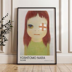 May include: Framed art print featuring a large-eyed girl with red hair, a bandage over one eye, and a green shirt. The print includes the artist's name, "YOSHITOMO NARA," and Japanese characters, along with dates.