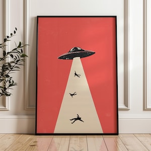 Könnte beinhalten: Gerahmter Kunstdruck mit einer schwarz-weißen UFO, das drei Silhouetten vor rotem Hintergrund entführt. Das UFO befindet sich über einem weißen Lichtstrahl. Das Kunstwerk ist in einem schwarzen Rahmen.