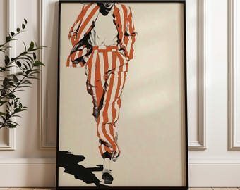 May include: A framed art print featuring a fashion illustration of a person in a red and white striped suit. The artwork is set against a neutral background, with a black shadow cast on the floor. The print is in a black frame.