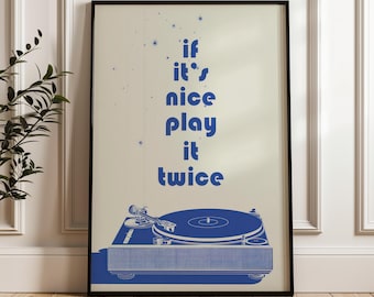 May include: A framed print featuring a blue turntable illustration with the text "if it's nice play it twice" in blue. The artwork has a cream-colored background and is set in a black frame. The overall theme is music and retro design.