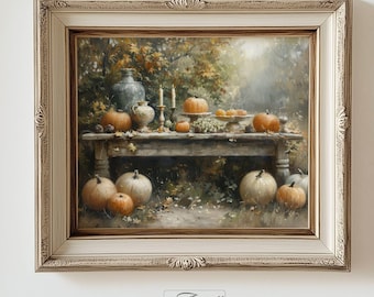 May include: A framed painting depicts a fall harvest scene. A wooden table is laden with pumpkins, gourds, and candles. The artwork is set in a natural outdoor setting with a cream-colored ornate frame. The painting is signed "Artville County".