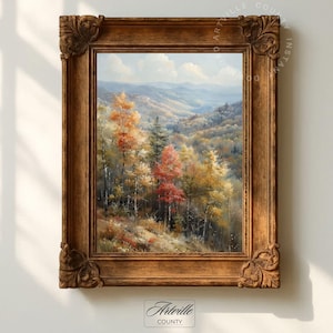 Könnte beinhalten: Gerahmtes Landschaftsgemälde mit einer herbstlichen Waldszene. Das Kunstwerk zeigt Bäume mit roten, orangefarbenen und gelben Blättern vor dem Hintergrund sanfter Hügel und eines blauen Himmels. Der verzierte, braune Holzrahmen verleiht dem Kunstwerk einen klassischen Touch.