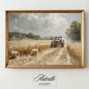 Puede incluir: Una pintura de paisaje enmarcada representa un tractor rojo conduciendo por un campo de trigo bajo un cielo nublado. Dos balas de heno est&aacute;n en primer plano. La pintura tiene un marco dorado y el texto "Artville County" en la parte inferior.