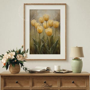 May include: A framed painting of a bouquet of yellow tulips with green leaves against a muted background.