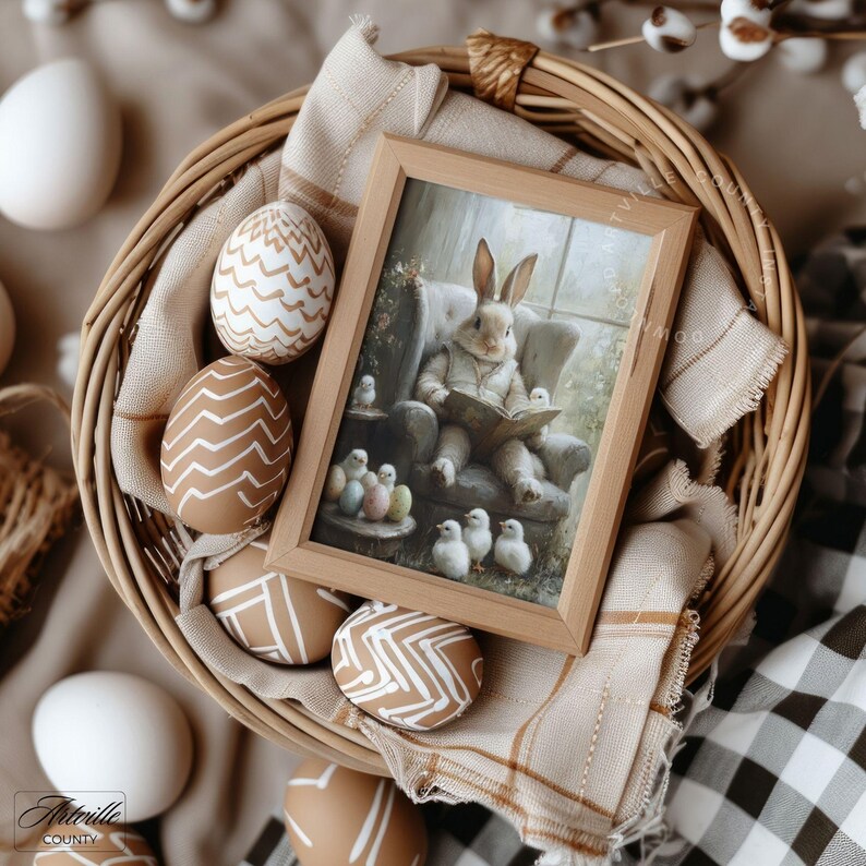 May include: A woven basket filled with decorated Easter eggs and a framed picture. The picture depicts a rabbit reading to chicks. The eggs are brown and white with geometric designs. A beige cloth and a checkered pattern fabric are also in the basket.