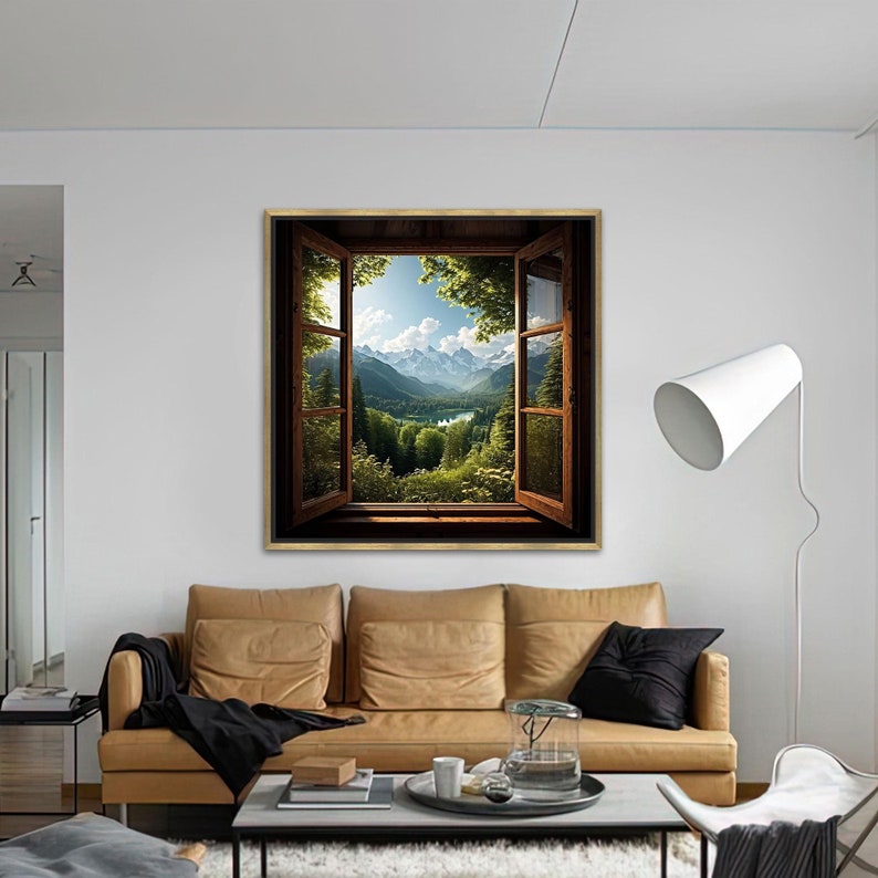 May include: A framed print of a window looking out onto a mountain range with a lake in the valley. The window is open and the view is framed by green trees.