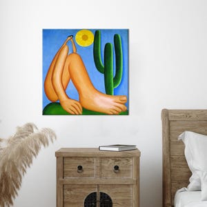 May include: A painting of a nude figure sitting with one leg extended, against a blue background with a yellow sun and a green cactus.