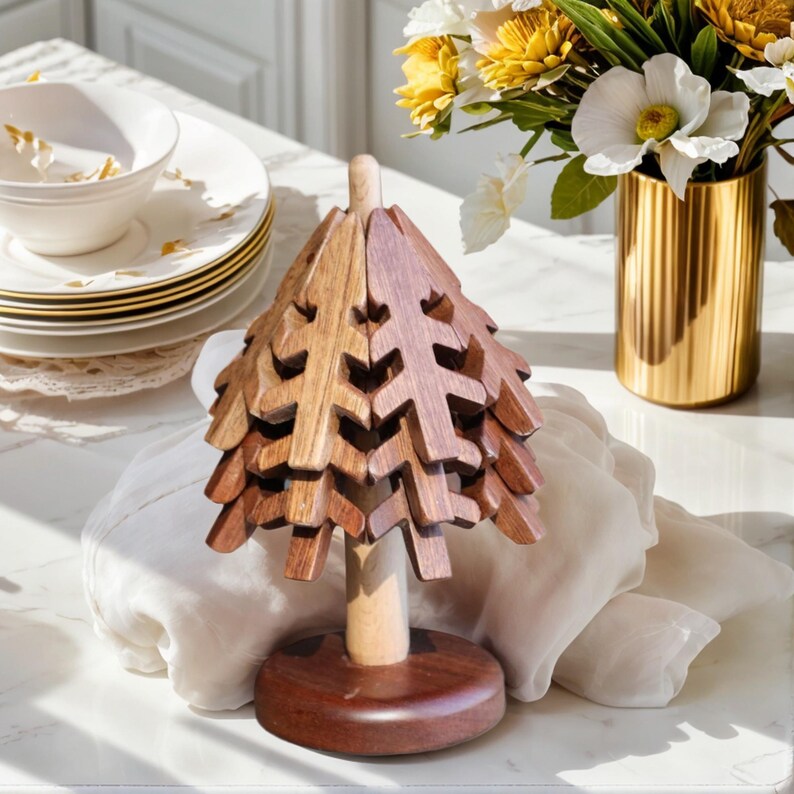 May include: A wooden, brown, folded, tree-shaped napkin holder with a round base. The holder is on a white marble surface.