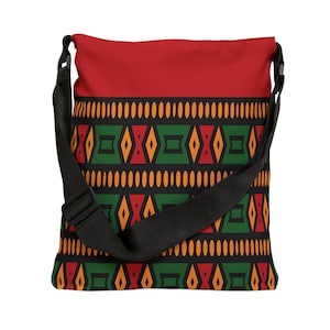 May include: A red and black shoulder bag with a geometric pattern in orange, green, and red. The bag has a black adjustable strap and a solid red top section. The pattern features diamond and oval shapes.