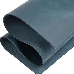 May include: A folded piece of blue leather. The leather has a smooth, textured surface.