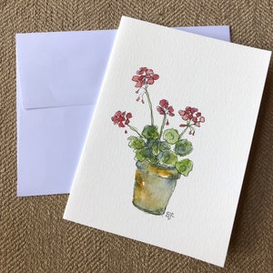 May include: A watercolor painting of a potted plant with pink flowers. The plant is in a brown pot and the flowers are in bloom. The painting is signed "sjc".